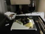 Square plate of cheeses with a glass of French Bordeaux