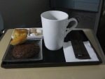 mug of coffee with chocolate cookie and madeleine