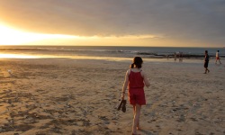 girl walking on the beach at sunset