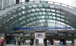 metal arches at Canary Wharf Underground Station with escalators