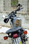 Tabby cat sitting on a motorcycle in Anofiotika Athens Greece