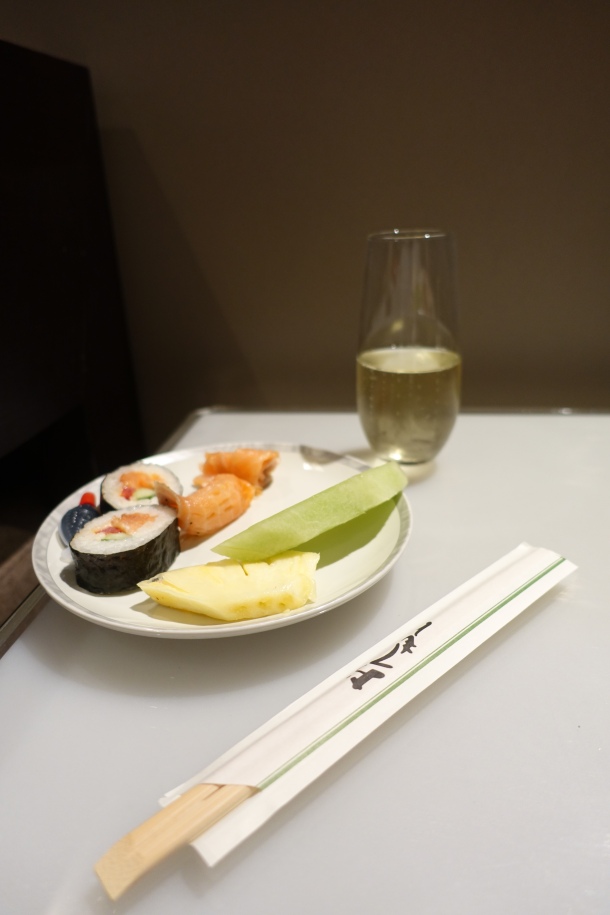 Plate of sushi and fruit, with a glass of Arras champagne in the Singapore Airlines Lounge in Perth