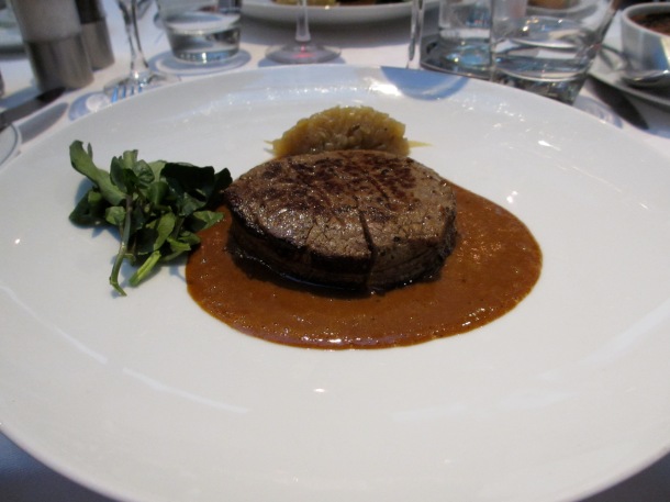 fillet steak with truffle sauce served on a white plate